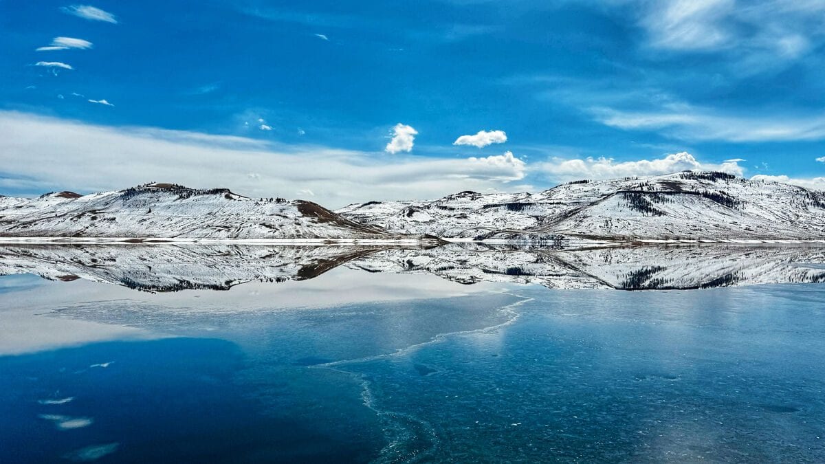 Snow-covered mountains reflected in a still lake