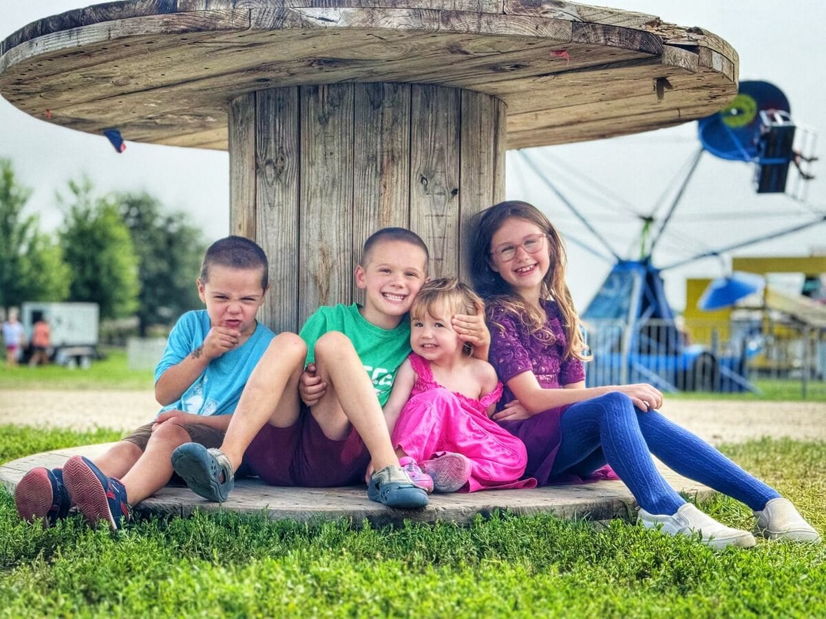 Six kids on a playground carousel