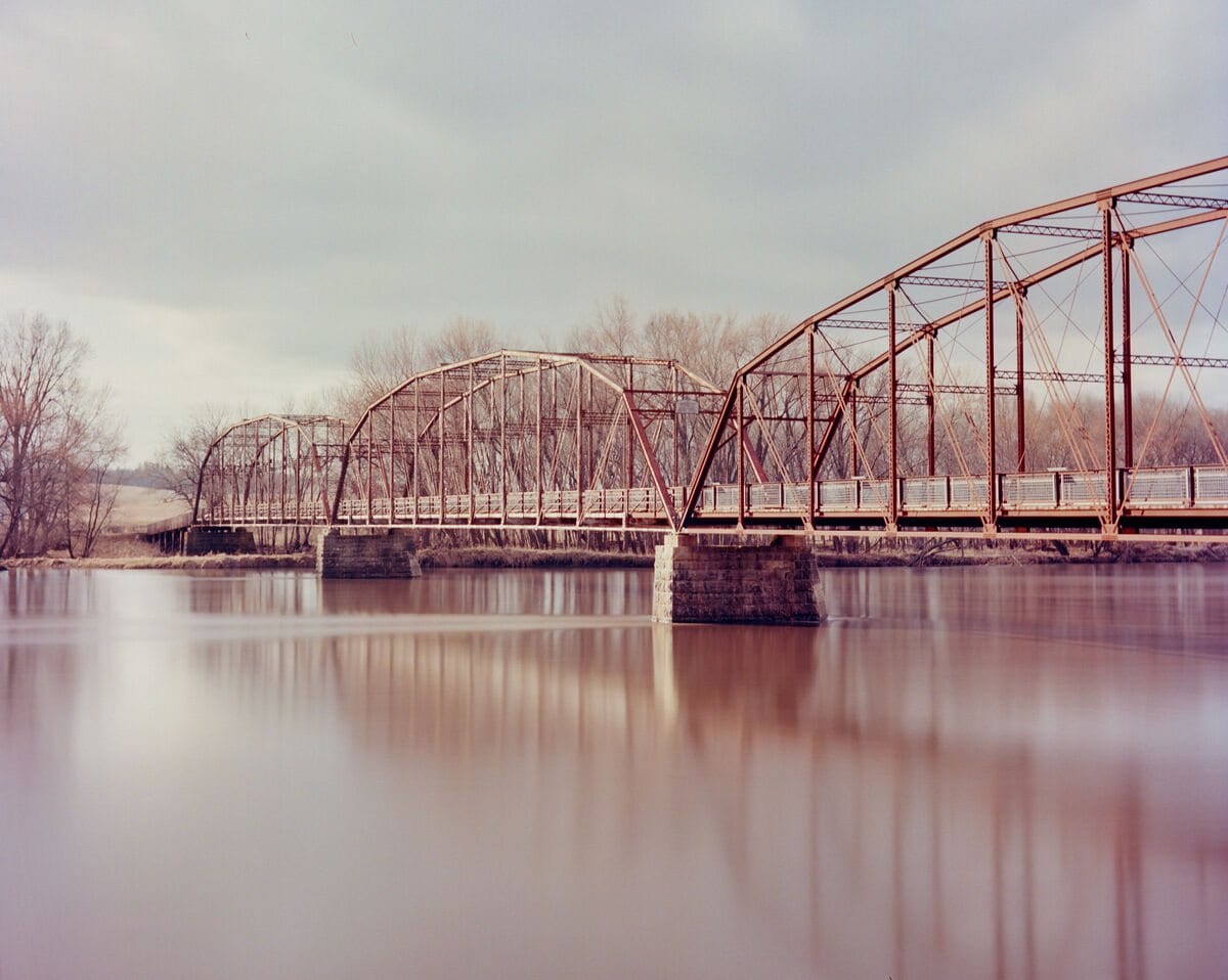 Truss bridge over a river in winter